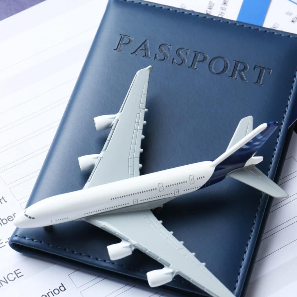 Toy airplane placed on a passport and documents, representing renouncing South African citizenship and its tax residency implications.